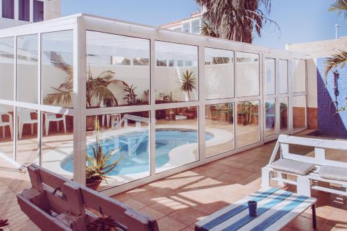 a building with a swimming pool inside of it at Aloe Vera Shared House in El Médano