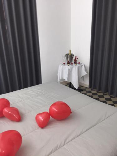 a group of red hearts on a white bed at VILLA ADELAIDE SUITE & ROOM in Torre a Mare