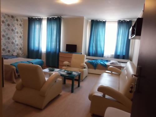 a living room with a couch and chairs and a bed at PATIO dom gościnny in Łukęcin