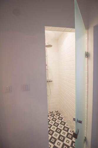 a bathroom with a shower with a glass door at Standard Apartment by Hi5 - Madách in Budapest