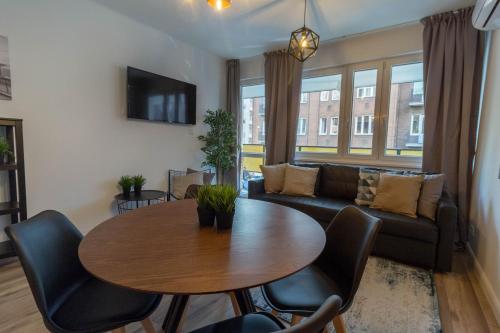 a living room with a table and a couch at Standard Apartment by Hi5 - Madách in Budapest