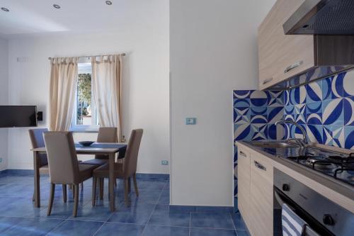 a kitchen and dining room with a table and chairs at Casa Restituta in Ischia