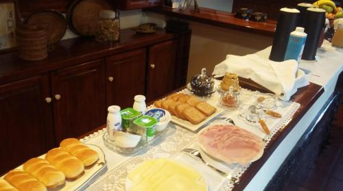 a table with different types of bread and other foods at A Tejada in Ortiga