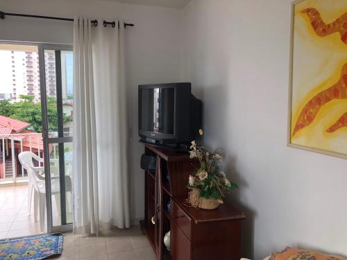 a tv sitting on a dresser in a living room at Aconchegante apartamento a beira mar barra velha in Barra Velha