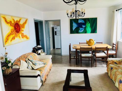 a living room with a couch and a table at Aconchegante apartamento a beira mar barra velha in Barra Velha