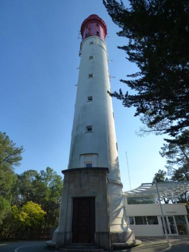 a white lighthouse sitting in front of a building at Les Marinas de Cassy in Lanton
