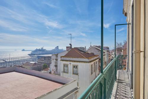 a balcony with a view of the ocean and a cruise ship at Rua dos Remédios 179 in Lisbon