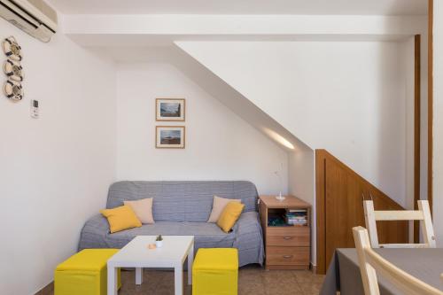a living room with a couch and a table at Eco Apartments Kate in Suđurađ