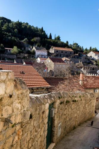 a view of a city from behind a stone wall at Eco Apartments Kate in Suđurađ