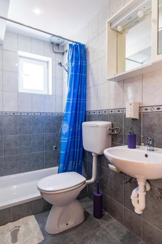 a bathroom with a toilet and a sink at Eco Apartments Kate in Suđurađ