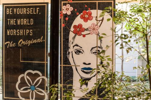 a poster of a woman with flowers on her head at Sakura Terrace The Atelier in Kyoto