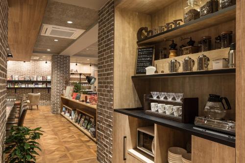 a restaurant with a counter and shelves with dishes at Sakura Terrace The Atelier in Kyoto