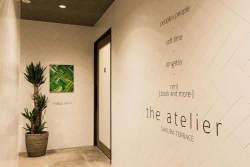 a hallway with writing on the wall at Sakura Terrace The Atelier in Kyoto