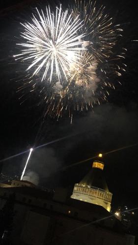 a fireworks display with a building in the background at Aleen Guest House in Nazareth