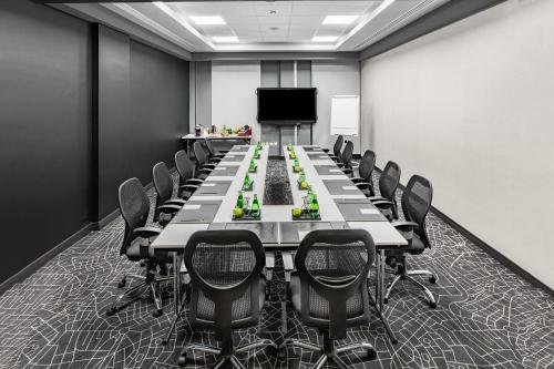 a conference room with a long table and chairs at Park Inn by Radisson Jubail Industrial City in Al Jubail