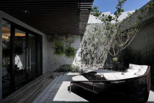 an outdoor patio with a couch and a table at Ease Motel Taichung in Taichung