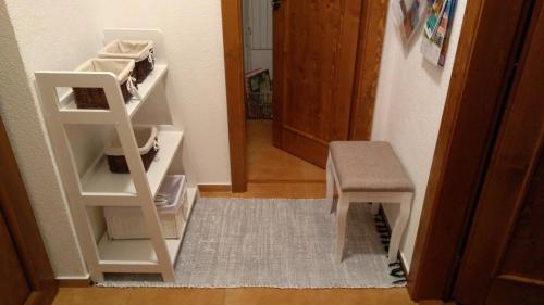 a room with a stair case and a stool and a door at MJ Vila in Stará Lesná