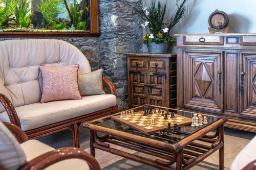 a living room with a chessboard on a table at Hotel Les Arolles in Méribel