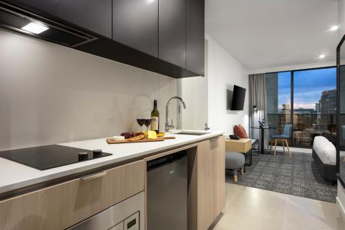 a kitchen with a sink and a counter top at Quest NewQuay in Melbourne