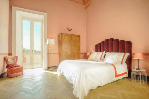 a bedroom with a large bed and a large window at Relais Monastero Santa Teresa - Albergo Diffuso in Nardò