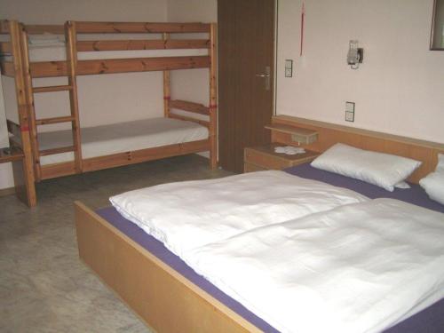 a bedroom with two bunk beds and a bed at Rotes Ross in Burghaslach