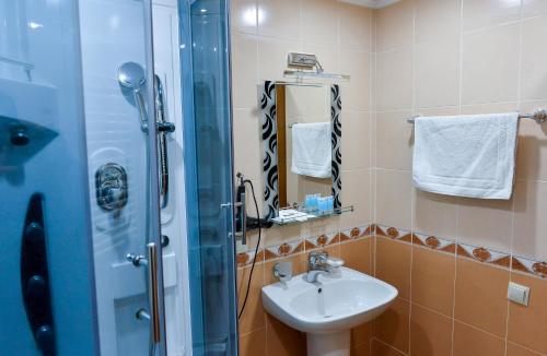 a bathroom with a sink and a shower at Hotel Old Town in Kutaisi