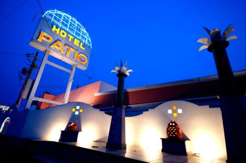 a night view of a hotel with a neon sign at Hotel Patio Ise (Adult Only) in Ise