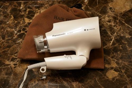 a white hair dryer sitting on top of a towel at Rihga Royal Hotel Hiroshima in Hiroshima