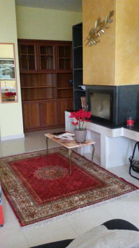 a living room with a table and a fireplace at "La casa di Mariagrazia" Appartamento 4 locali in Sammichele di Bari