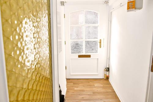 a hallway with a white door and a window at Townhouse Duderstadt in Duderstadt