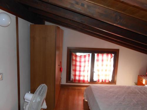 a bedroom with a bed and a window at OLD FARM HOUSE in Riomaggiore