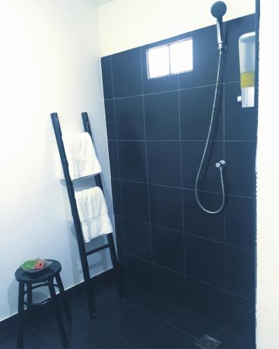 a bathroom with a shower with a blue tile wall at Papillon Bungalows in Ko Lanta