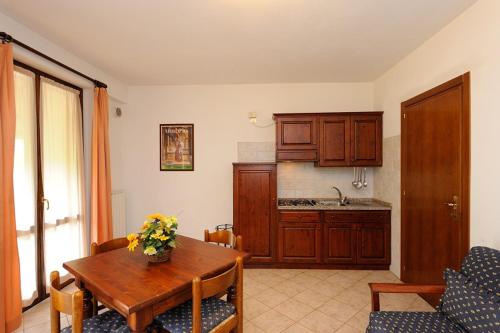 a kitchen with a wooden table and a dining room at Agriturismo Belsito Pian Di Boccio in Bevagna