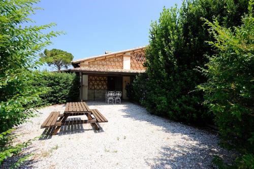 a patio with two benches and a table in front of a building at Agriturismo Belsito Pian Di Boccio in Bevagna