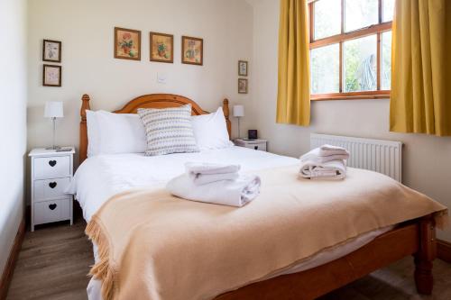 1 dormitorio con 2 camas y toallas en la cama en 7 The Uplands, en Thorpeness