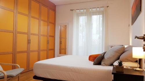 a bedroom with a large bed and a window at URBIETA CENTRO in Donostia-San Sebastián