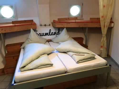 a bed in a room with pillows on it at Bergwerksilo Herznach in Herznach