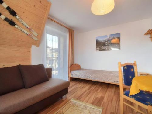 un soggiorno con divano e letto di Ceperka a Zakopane