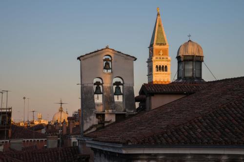 a view of a city with a clock tower and roofs at Al Theatro Palace in Venice