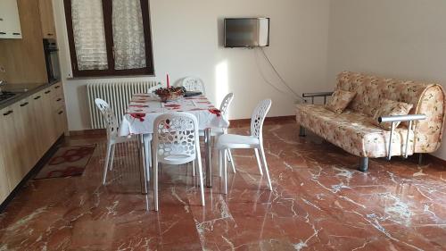 a dining room with a table and chairs and a couch at Da Pietro in Pietra in La Martella
