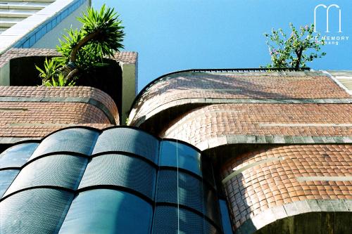 a brick building with plants on top of it at The Memory - Danang in Da Nang