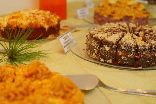 a table with three cakes on a table at Pousada Magnus in Balneário Camboriú
