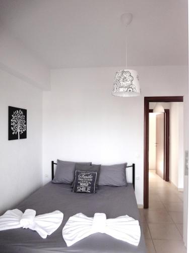 a bedroom with a bed with two bow ties on it at Polychrono Nikos Apartment in Polychrono