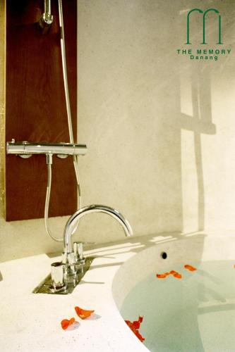 a bathroom with a sink with blood on it at The Memory - Danang in Da Nang