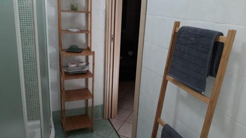 a bathroom with a towel rack and a mirror at Residenze Mquadro in Verona