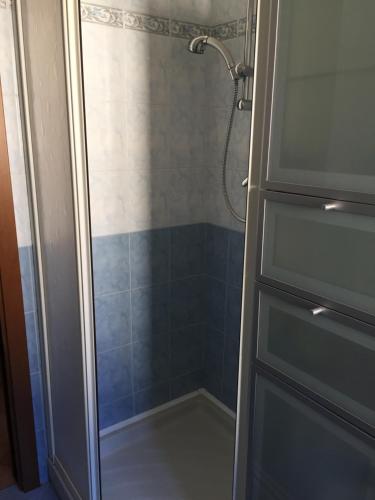 a bathroom with a shower with a glass door at Casa Grazia in Magreglio
