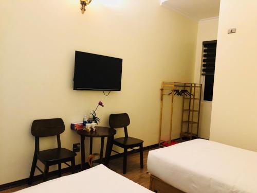 a bedroom with a bed and two chairs and a table at Ninh Binh Brother's Homestay in Ninh Binh