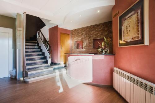 a hallway with a staircase and a brick wall at Hotel El Cid in Morella