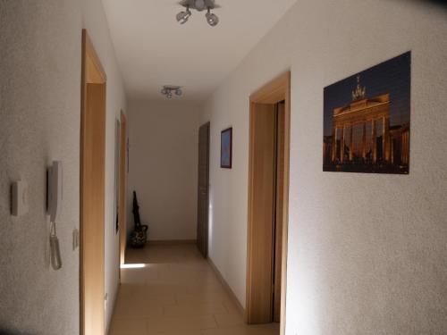a hallway with a hallway leading into a room with a painting on the wall at Apartment FALVIG inkl. Küche in Bad Schonborn
