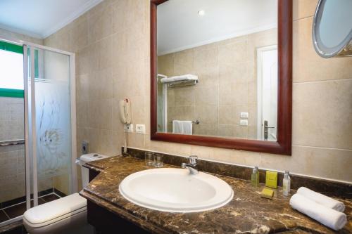 a bathroom with a toilet, sink, and shower at Swiss Inn Resort Hurghada in Hurghada